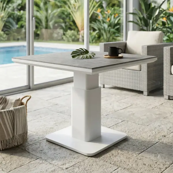 The LUKA Adjustable Height Table brings effortless versatility to your outdoor space, making it easy to shift from casual mornings with coffee to relaxed dining with family and friends. Its clean white frame and modern concrete-look top create a fresh, elevated style that complements any setting. Designed for everyday living, it offers a smooth, simple height adjustment so you can adapt your space in seconds. Whether you’re hosting, relaxing, or enjoying a quiet moment outside, Luka makes every experience feel easy, comfortable, and beautifully put together. Robust powder-coated aluminum construction with stainless steel hardware Durable ceramic top with a concrete look finish can withstand temperatures ranging from -40°F to 500°F Highly resistant to scratching, staining, discoloring, and warping All-in-one Coffee & Dining Table! Easily & quickly adjusts between 19" H to 29" H for convenient versatility No umbrella hole, perfect for cantilever umbrellas Integrated foot levelers prevent wobbling on uneven floors and prolong furniture life Frame Color: White Top Color: Concrete Look - alternate view