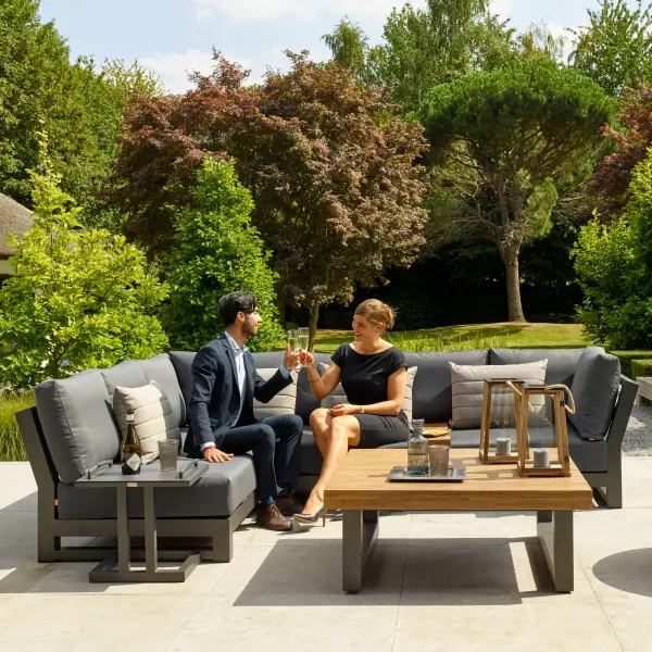 The Nevada Corner Conversation Set combines robust powder-coated aluminum with Indonesian teak for a sophisticated outdoor entertaining space. Features weather-resistant Sunbrella cushions and spacious seating for family gatherings. - alternate view