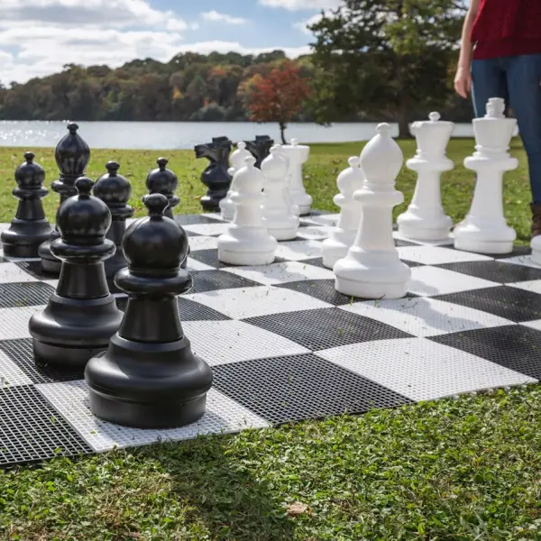 This impressive giant chess set features 32 oversized pieces (19"-25" tall) and a 10'x10' game board, ideal for backyards, resorts, and recreation centers. Durable all-weather resin construction with ballast capability.