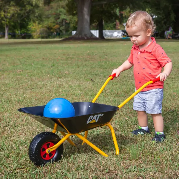 This sturdy children's wheelbarrow features a seamless steel tub with rust-resistant powder coat finish and oversized blow-molded wheel. Perfect for helping with yard work or transporting toys outdoors. - alternate view