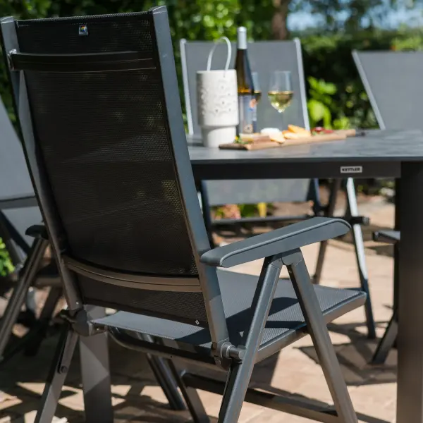 The Basic Plus 5-Piece Dining Set combines German engineering with practical outdoor functionality. Features quick-drying Textilene sling chairs with 4-position reclining backs, a scratch-resistant HPL table top, and powder-coated aluminum frames built to withstand the elements. - alternate view