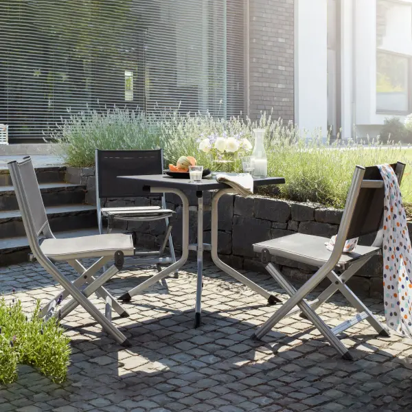 The Basic Plus Folding Side Chair combines durable aluminum construction with quick-drying Textilene sling fabric for comfortable, weather-resistant outdoor seating that folds compactly for easy storage. - alternate view
