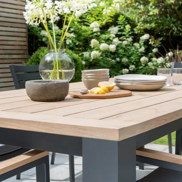 The Elba 9-Piece Dining Set delivers exceptional outdoor entertaining with FSC-certified teak, weatherproof aluminum framing, and stackable chairs featuring thick foam cushions in fade-resistant Sunbrella fabric. - alternate view