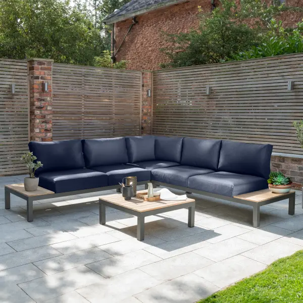 The Elba 4-piece corner set combines sleek aluminum construction with natural teak accents for a sophisticated outdoor living space. Featuring weather-resistant Sunbrella cushions and modular flexibility, this set comfortably seats 4 and adapts to various patio configurations. - alternate view