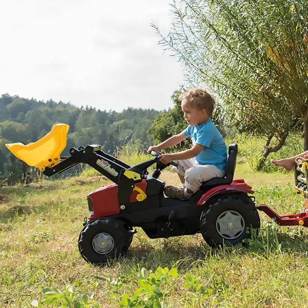 The Case IH Farmtrac combines durability with authentic play features including a functional front loader, adjustable seat, and whisper-quiet tires. German engineering ensures years of indoor and outdoor use. - alternate view