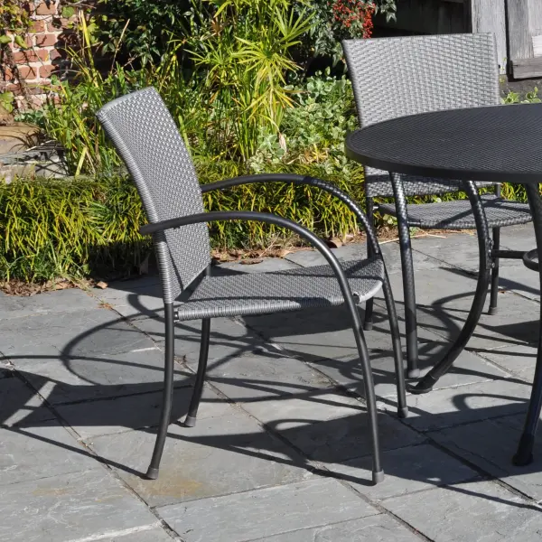 The Pilano combines modern aesthetics with practical durability. Features proprietary Electrotherm coating that resists fading and stays cooler to touch, hand-woven weatherproof polymer seating, and stackable chairs for easy storage. - alternate view