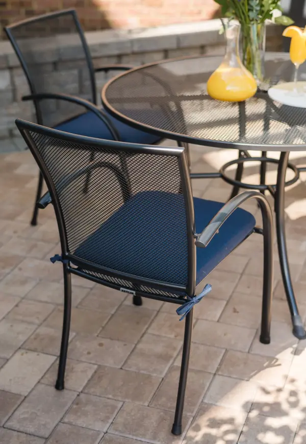 The Pilano 5-piece dining set combines contemporary design with exceptional durability. Features proprietary Electrotherm coating that resists fading and stays cooler to the touch, plus stackable chairs for easy storage. - alternate view