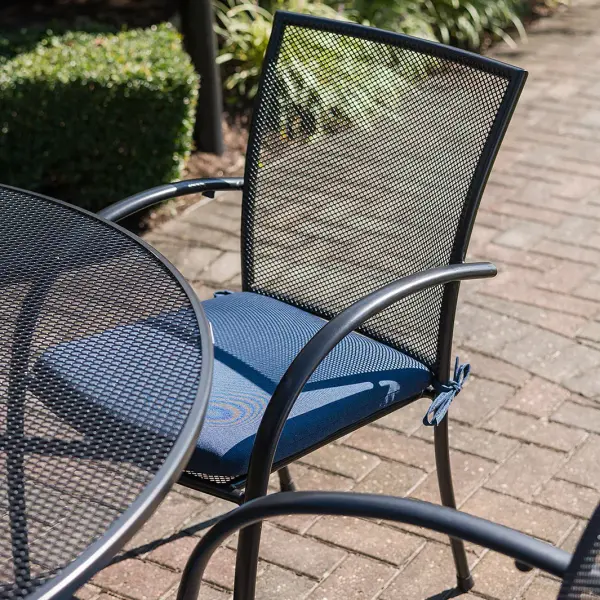 The Pilano dining set combines modern style with exceptional durability. Features proprietary Electrotherm coating that resists fading and stays cooler to touch. Includes 6 stackable mesh chairs and 60-inch round table with umbrella hole. - alternate view