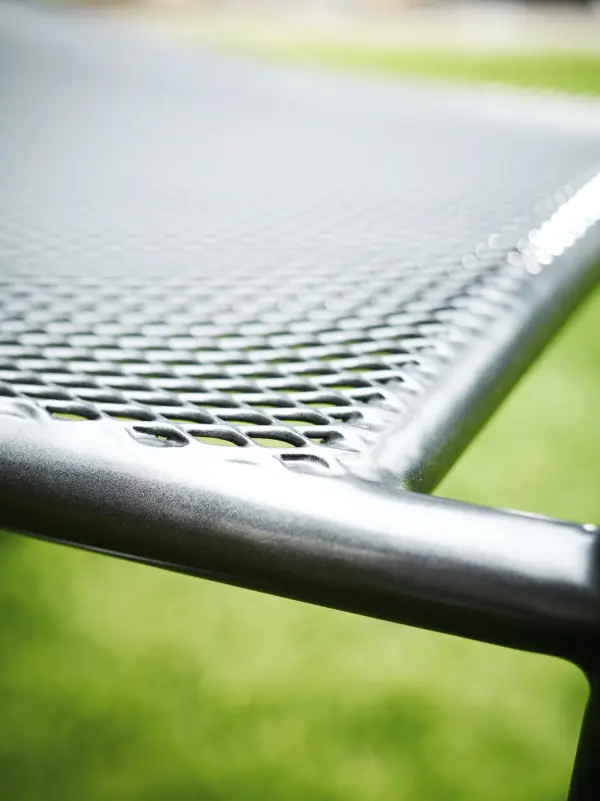 The Carlo stackable bar chair combines commercial-grade durability with space-saving functionality. Its metal mesh construction provides ventilated comfort that dries quickly, while the proprietary Electrotherm coating resists fading and stays cooler to the touch. - alternate view