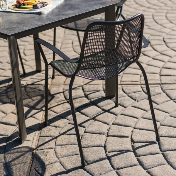 These stackable Metro arm chairs combine sleek modern design with exceptional outdoor durability. The proprietary Electrotherm coating resists fading and stays cooler to the touch, while the contoured bucket seat ensures comfort for extended dining. - alternate view
