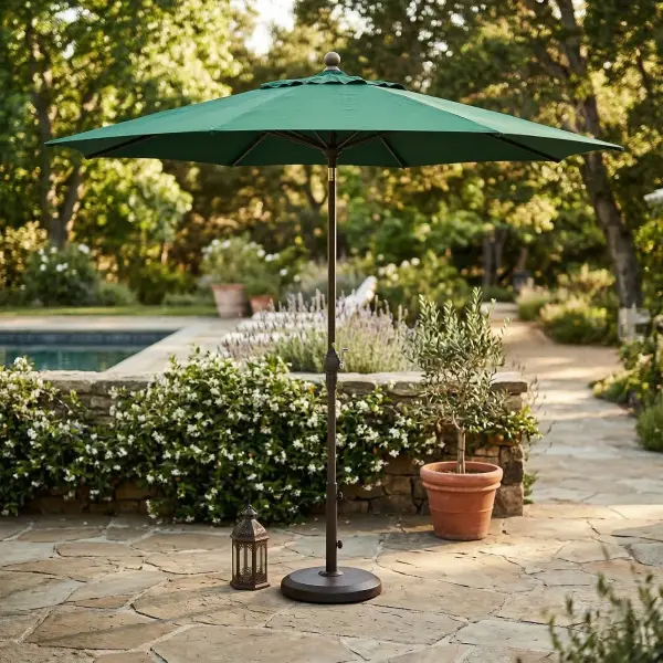 Stay comfortably shaded with the 9' Auto-Tilt Market Umbrella , designed for easy, adjustable sun protection throughout the day. The smooth crank lift with durable steel cable opens the umbrella effortlessly, while the auto-tilt feature lets you angle the canopy as the sun moves. Built with an antique bronze frame, eight sturdy ribs, and solid resin hubs, it offers reliable performance for residential patios and decks. Ideal for tables up to 54", it features a 1.5" pole and is available in Forest Green, Jockey Red, and Navy Blue. Deluxe Auto Tilt Crank Lift (Steel Cable) Threaded Coupling Solid Resin Hubs and Finial Auto Locking Metal Housing 8 Ribs Residential applications Ideal shade coverage: up to 54” tables Auto locking mechanism permits tilt to be used at any desired angle Pole Diameter 1.5" Frame: Antique Bronze Fabrics: Forest Green, Jockey Red and Navy Blue BASE NOT INCLUDED - alternate view