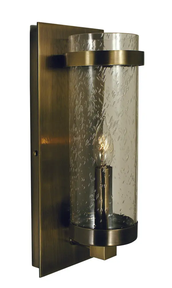 The Hammersmith sconce combines traditional antique brass metalwork with handcrafted clear seedy glass for timeless elegance. Its compact 5-inch width makes it ideal for smaller spaces while the 12.5-inch height provides substantial presence.
