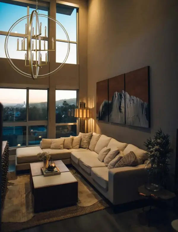 The Constellation pendant makes a bold architectural statement with 16 candelabra lights arranged in a striking 45-inch wide configuration. The satin brass and white two-tone finish adds sophisticated contrast to this oversized fixture. - alternate view