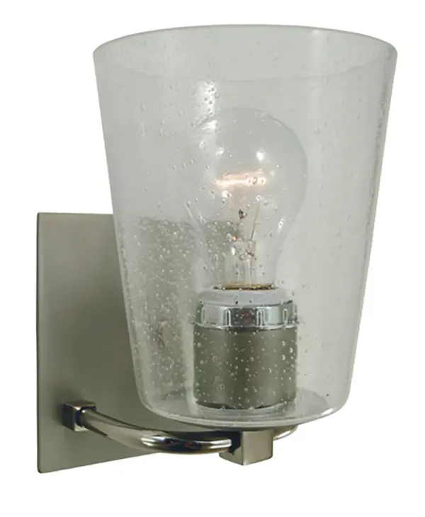 The Mercer bath sconce combines transitional elegance with industrial charm. Its clear seedy glass cone shade and mixed metal finish create visual interest while providing functional task lighting for bathrooms and vanities.