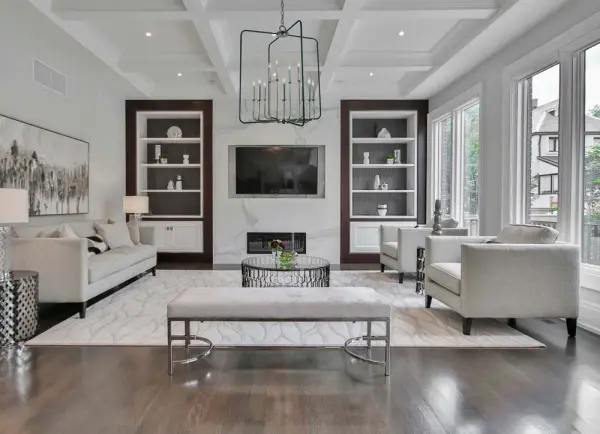 The Boulevard foyer chandelier makes a bold architectural statement with 12 candle-style lights arranged in a sophisticated mixed-metal design. Its substantial 34-inch width and dramatic vertical presence create impressive visual impact. - alternate view