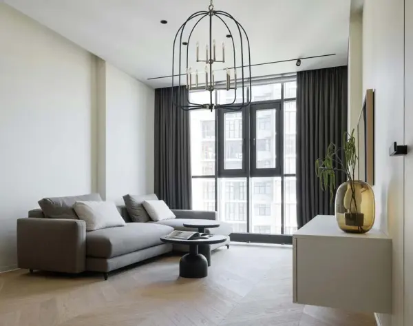 This impressive 12-light foyer chandelier combines polished nickel and matte black finishes for a striking transitional aesthetic. At 36 inches wide and extending up to 121 inches, it's designed for grand spaces with high ceilings. - alternate view