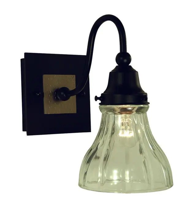 The Houghton sconce combines matte black and brushed nickel finishes with clear glass for a sophisticated accent light. Its compact 5-inch square profile makes it ideal for smaller spaces while delivering contemporary style.