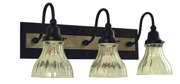 The Houghton 3-Light Sconce combines matte black and brushed nickel finishes for a striking contemporary look. Clear glass shades showcase vintage-style bulbs while the 21-inch width provides substantial illumination.