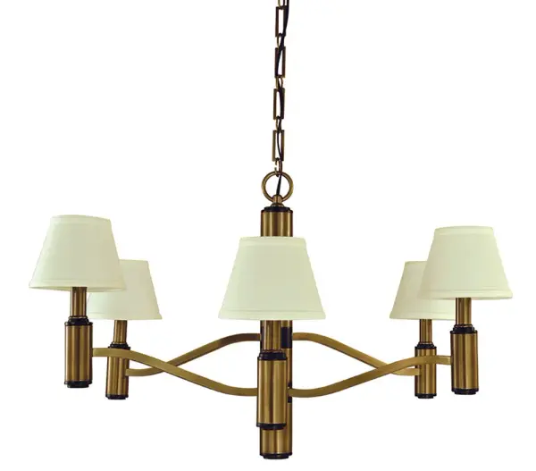 The Hampton chandelier combines antique brass with matte black accents for a sophisticated transitional look. Six candle-style lights with off-white linen shades provide warm, diffused illumination perfect for dining spaces.