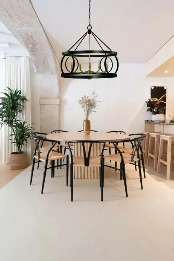 The Amelia chandelier combines matte black and satin brass finishes in a substantial 33-inch frame. Five candle-style lights create dramatic illumination perfect for large dining spaces and grand entryways. - alternate view