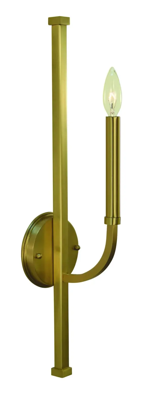 The Manhattan Bath Sconce delivers contemporary elegance with its slender 23-inch vertical profile and brushed brass finish. Perfect for flanking mirrors or creating dramatic vertical lighting in bathrooms and hallways.