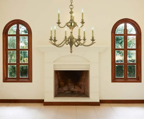 The Scarsdale chandelier combines transitional elegance with contemporary clean lines. Nine candelabra lights provide ample illumination, while the brushed brass finish adds warmth and sophistication to dining spaces. - alternate view