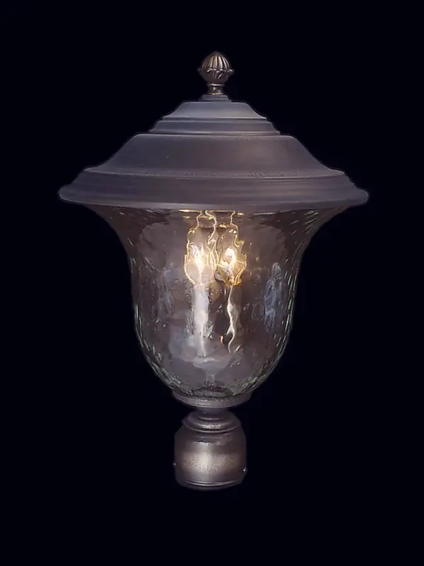 The Carcassonne exterior post mount brings Old World charm to outdoor spaces with its iron finish and clear mottled glass shades. Three candelabra lights provide warm ambient illumination for entryways and pathways.