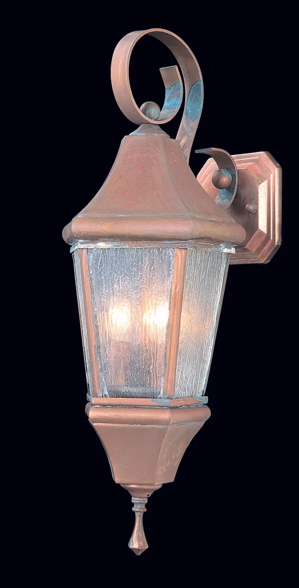 The Normandy 3-Light Wall Mount brings Old World charm to exterior spaces with its handcrafted raw copper finish and romantic rain glass. Perfect for creating an inviting entrance with traditional European elegance.