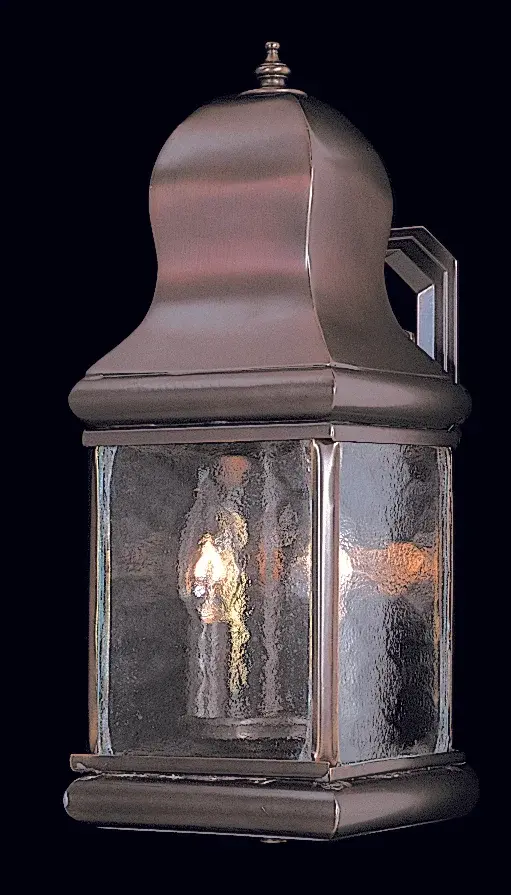 This distinctive outdoor wall lantern stands out with its impressive height and unique staggered candle arrangement. Solid brass construction ensures durability and longevity in exterior applications.