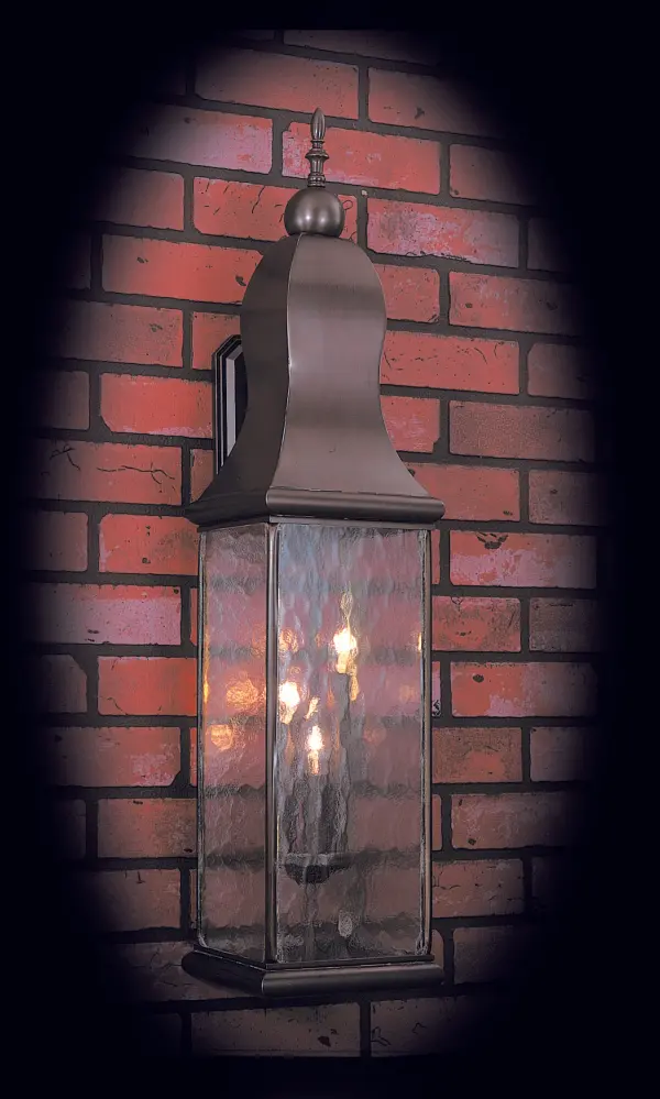 This tall exterior wall lantern stands out with its impressive height and staggered candelabra configuration. Crafted entirely from solid brass in the USA, it delivers superior light distribution and lasting durability for outdoor spaces.