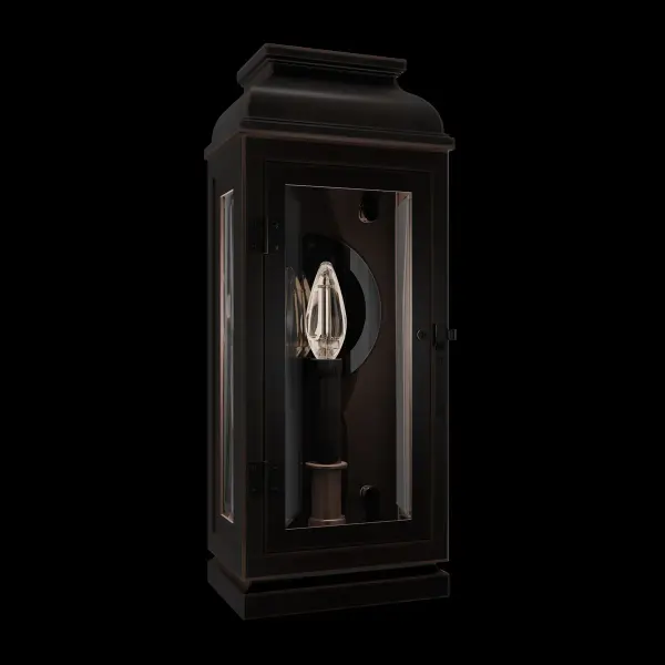 La Motte is a classically inspired outdoor wall lantern that exudes timeless elegance with its old-world charm and luxurious details. Ornamental beading accents the gable at the top, while finial-style balls adorn each corner of the roof. The slightly tapered frame features a hinged clear glass door, revealing a trio of candles mounted on the back wall. A simple, incised round mirror enhances the warm glow, creating an inviting ambiance.