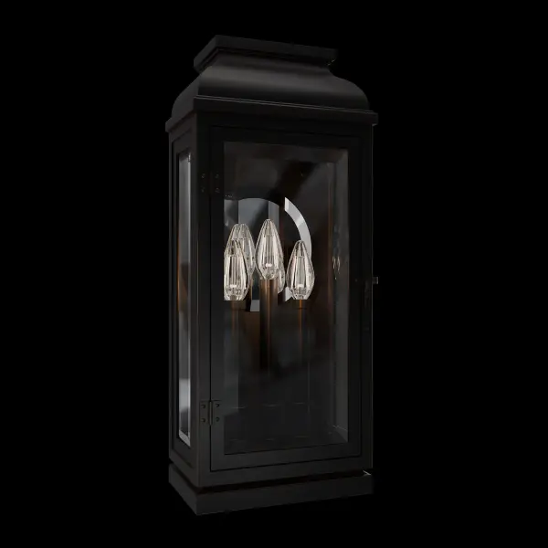 La Motte is a classically inspired outdoor wall lantern that exudes timeless elegance with its old-world charm and luxurious details. Ornamental beading accents the gable at the top, while finial-style balls adorn each corner of the roof. The slightly tapered frame features a hinged clear glass door, revealing a trio of candles mounted on the back wall. A simple, incised round mirror enhances the warm glow, creating an inviting ambiance.