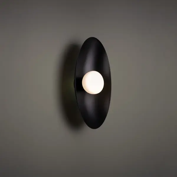 Glitz and style. A circle within a circle casts reflected illumination off a lustrous surface. Collection: Glamour Sub-Brand: DweLED Finish: Black Notes: Glamour 18" LED Wall Sconce 3500K In Black Width: 4.00" Height: 18.00" Length: 9.00" Weight: 3.53 lb Extension from Wall: 9.00" Bulbs Included Number of Bulbs: 1 Maximum Wattage: 7.00 W Bulb Type: Module Light Source: LED Light Output: 577.00 lm Delivered Lumens: 226.00 lm Color Temperature: 3500 K CRI: 90 Dimmable Rated Average Life: 54000 Voltage: 120.00 V Material: Metal body with metal shade and glass diffuser Country of Origin: China Safety Listing: ETL, cETL LED Manufacturer Warranty: 5 year