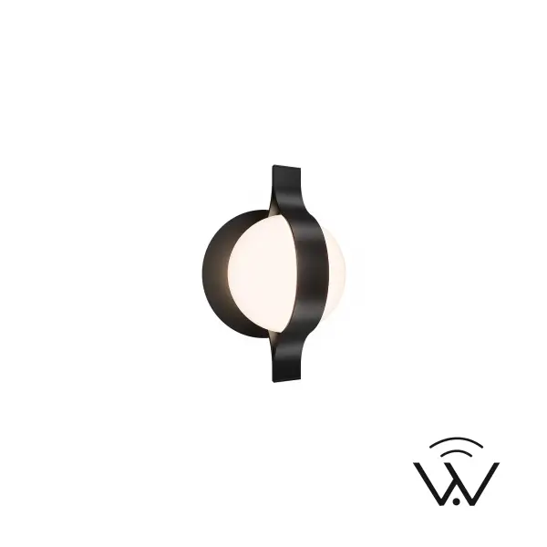 Ellaria is a study in balance — a glowing opal glass sphere wrapped in a bold metal band that’s both sculptural and refined. Compact yet eye-catching, it adds warmth and character to any wall, blending timeless materials with contemporary style.