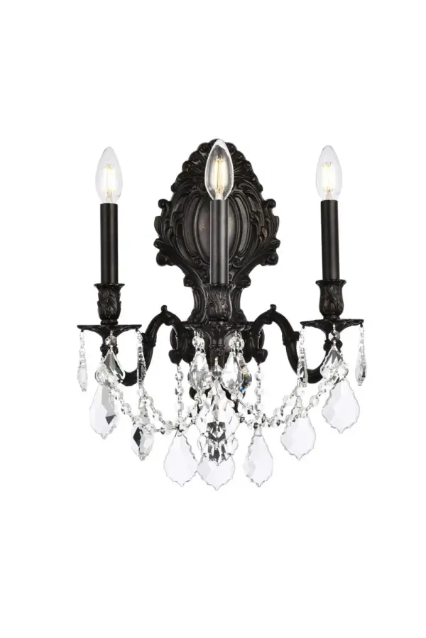 Regal and distinct, the Monarch collection of wall sconces flaunts a swirling vision of scrolls and crystal. A graceful oval backplate, accented with ornate curlicues, supports one, two, three, or five scrolled arms. The frame is finished in pewter, dark bronze, or French gold. Sculpted candle holders add to the dramatic effect, while the soft candelabra lights (bulbs not included) add the finishing touch to this spectacular design. A majestic addition to an entryway, office, or bathroom. Collection: Monarch Rooms: Hallway, Living room, Bedroom, Bathroom, Entry Way, Finish: Dark Bronze Crystal: clear Notes: Royal Cut Crystal (Clear) Width: 14.00" Height: 18.00" Length: 14.00" Weight: 12.00 lb Extension from Wall: 9.50" Wire: 23.62" Canopy: 7``x16.14`` Number of Bulbs: 3 Maximum Wattage: 40.00 W Bulb Type: B10 Bulb Base: E12 Dimmable Voltage: 110.00 V Material: Brass and Crystal Country of Origin: China Safety Listing: UL / Ulc Safety Rating: Damp Title 20 Title 24 Manufacturer Warranty: 1 year limited