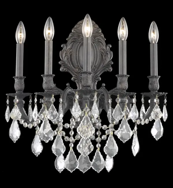 Regal and distinct, the Monarch collection of wall sconces flaunts a swirling vision of scrolls and crystal. A graceful oval backplate, accented with ornate curlicues, supports one, two, three, or five scrolled arms. The frame is finished in pewter, dark bronze, or French gold. Sculpted candle holders add to the dramatic effect, while the soft candelabra lights (bulbs not included) add the finishing touch to this spectacular design. A majestic addition to an entryway, office, or bathroom. Collection: Monarch Rooms: Hallway, Living room, Bedroom, Bathroom, Entry Way, Finish: Dark Bronze Crystal: clear Notes: Royal Cut Crystal (Clear) Width: 21.00" Height: 24.00" Length: 21.00" Weight: 22.00 lb Extension from Wall: 11.00" Wire: 23.62" Canopy: 7``x16.14`` Number of Bulbs: 5 Maximum Wattage: 40.00 W Bulb Type: B10 Bulb Base: E12 Dimmable Voltage: 110.00 V Material: Brass and Crystal Country of Origin: China Safety Listing: UL / Ulc Safety Rating: Damp Title 20 Title 24 Manufacturer Warranty: 1 year limited