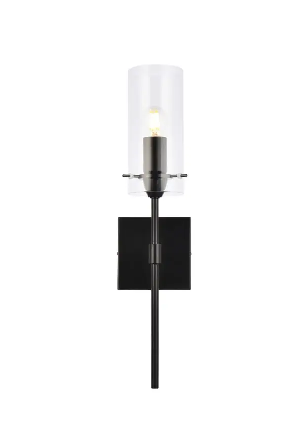 Brighten your space with the Elsreth Collection wall sconce. The cylinder glass and straight arm creates a modern candle lit look. Available in black or brass finish this lamp will illuminate the room. This product is dimmable and requires one E26 socket. Light bulbs not included. Collection: Elsreth Rooms: Dining room, Living room, Bedroom, Bathroom, Entry Way, Closet Finish: Black and Clear Glass: Clear Width: 4.30" Height: 20.00" Length: 4.70" Weight: 2.00 lb Extension from Wall: 4.30" Wire: 11" Black and White Canopy: 4.7"x4.7"x1" Number of Bulbs: 1 Maximum Wattage: 40.00 W Bulb Type: E26 Bulb Base: E26 Dimmable Voltage: 110.00 V Material: Iron and Glass Country of Origin: China Safety Listing: ETL Safety Rating: Damp Title 20 Title 24 Manufacturer Warranty: 1 year limited Spec Sheet