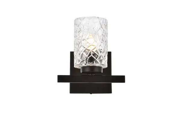 In all of its auspicious glory, the Cassie collection wall lamp will shine its felicitous light for you. As the light passes through the shade, it dances around with the shadows and puts a spotlight in your room. Whether it is in your entryway or bathrooms, this 1-light wall lamp will surely please you and your guests. Collection: Cassie Rooms: Dining room, kitchen, living room, entry way Finish: Black and Clear Shade Glass: Clear Width: 5.50" Height: 7.70" Length: 7.50" Weight: 2.50 lb Extension from Wall: 5.50" Wire: 6" Black and White Canopy: 4.7"x4.7"x0.8" Number of Bulbs: 1 Maximum Wattage: 40.00 W Bulb Type: E-12 Bulb Base: E12 Dimmable Voltage: 110.00 V Material: Metal and Glass Country of Origin: China Safety Listing: ETL Safety Rating: Damp Title 20 Title 24 Manufacturer Warranty: 1 year limited Spec Sheet