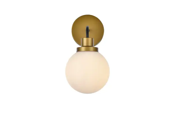 In all of its auspicious glory, the Hanson collection wall lamp will shine its felicitous light for you. As the light passes through the shade, it dances around with the shadows and puts a spotlight in your room. Whether it is in your entryway or bathrooms, this 1-light wall lamp will surely please you and your guests. Collection: Hanson Rooms: Dining room, kitchen, living room, entry way Finish: Black and Brass and Frosted Shade Glass: Opal White Width: 8.50" Height: 11.70" Length: 6.00" Weight: 2.00 lb Extension from Wall: 8.50" Wire: 6" Black and White Canopy: 4.7"x4.7"x1" Number of Bulbs: 1 Maximum Wattage: 40.00 W Bulb Type: E12 Bulb Base: E12 Dimmable Voltage: 110.00 V Material: Metal and Aluminum and Glass Country of Origin: China Safety Listing: ETL Safety Rating: Damp Title 20 Title 24 Manufacturer Warranty: 1 year limited Spec Sheet