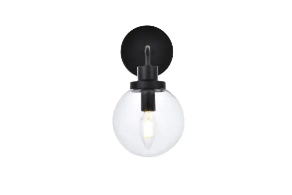 In all of its auspicious glory, the Hanson collection wall lamp will shine its felicitous light for you. As the light passes through the shade, it dances around with the shadows and puts a spotlight in your room. Whether it is in your entryway or bathrooms, this 1-light wall lamp will surely please you and your guests. Collection: Hanson Rooms: Dining room, kitchen, living room, entry way Finish: Black and Clear Shade Glass: Clear Width: 8.50" Height: 11.70" Length: 6.00" Weight: 2.00 lb Extension from Wall: 8.50" Wire: 6" Black and White Canopy: 4.7"x4.7"x1" Number of Bulbs: 1 Maximum Wattage: 40.00 W Bulb Type: E12 Bulb Base: E12 Dimmable Voltage: 110.00 V Material: Metal and Aluminum and Glass Country of Origin: China Safety Listing: ETL Safety Rating: Damp Title 20 Title 24 Manufacturer Warranty: 1 year limited Spec Sheet