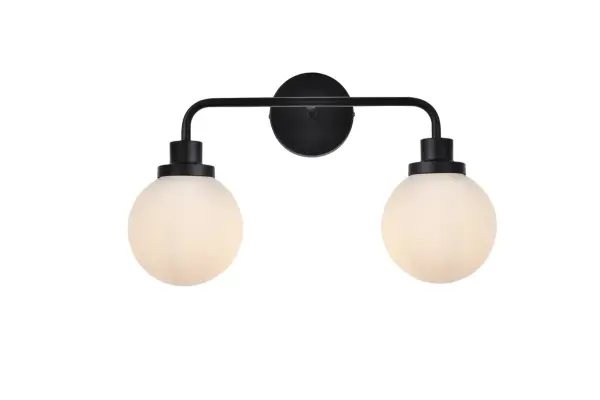In all of its auspicious glory, the Hanson collection wall lamp will shine its felicitous light for you. As the light passes through the shade, it dances around with the shadows and puts a spotlight in your room. Whether it is in your entryway or bathrooms, this 1-light wall lamp will surely please you and your guests. Collection: Hanson Rooms: Dining room, kitchen, living room, entry way Finish: Black and Frosted Shade Glass: Opal White Width: 8.00" Height: 11.70" Length: 19.00" Weight: 3.00 lb Extension from Wall: 8.00" Wire: 6" Black and White Canopy: 4.7"x4.7"x1" Number of Bulbs: 2 Maximum Wattage: 40.00 W Bulb Type: E12 Bulb Base: E12 Dimmable Voltage: 110.00 V Material: Metal and Aluminum and Glass Country of Origin: China Safety Listing: ETL Safety Rating: Damp Title 20 Title 24 Manufacturer Warranty: 1 year limited Spec Sheet