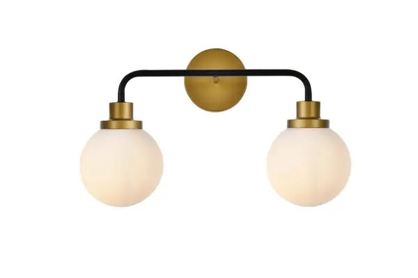 In all of its auspicious glory, the Hanson collection wall lamp will shine its felicitous light for you. As the light passes through the shade, it dances around with the shadows and puts a spotlight in your room. Whether it is in your entryway or bathrooms, this 1-light wall lamp will surely please you and your guests. Collection: Hanson Rooms: Dining room, kitchen, living room, entry way Finish: Black and Brass and Frosted Shade Glass: Opal White Width: 8.00" Height: 11.70" Length: 19.00" Weight: 3.00 lb Extension from Wall: 8.00" Wire: 6" Black and White Canopy: 4.7"x4.7"x1" Number of Bulbs: 2 Maximum Wattage: 40.00 W Bulb Type: E12 Bulb Base: E12 Dimmable Voltage: 110.00 V Material: Metal and Aluminum and Glass Country of Origin: China Safety Listing: ETL Safety Rating: Damp Title 20 Title 24 Manufacturer Warranty: 1 year limited Spec Sheet
