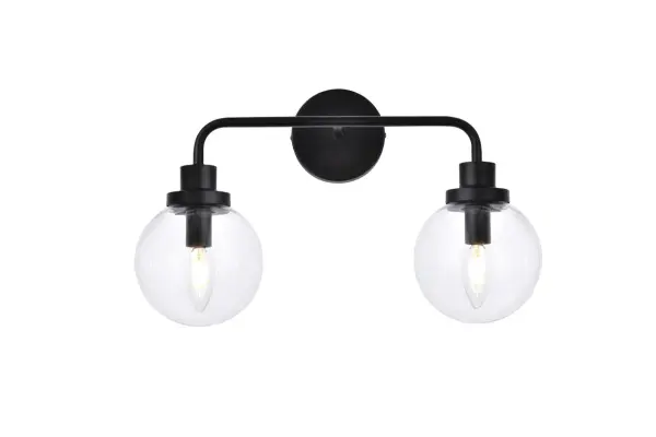 In all of its auspicious glory, the Hanson collection wall lamp will shine its felicitous light for you. As the light passes through the shade, it dances around with the shadows and puts a spotlight in your room. Whether it is in your entryway or bathrooms, this 1-light wall lamp will surely please you and your guests. Collection: Hanson Rooms: Dining room, kitchen, living room, entry way Finish: Black and Clear Shade Glass: Clear Width: 8.00" Height: 11.70" Length: 19.00" Weight: 3.00 lb Extension from Wall: 8.00" Wire: 6" Black and White Canopy: 4.7"x4.7"x1" Number of Bulbs: 2 Maximum Wattage: 40.00 W Bulb Type: E12 Bulb Base: E12 Dimmable Voltage: 110.00 V Material: Metal and Aluminum and Glass Country of Origin: China Safety Listing: ETL Safety Rating: Damp Title 20 Title 24 Manufacturer Warranty: 1 year limited Spec Sheet