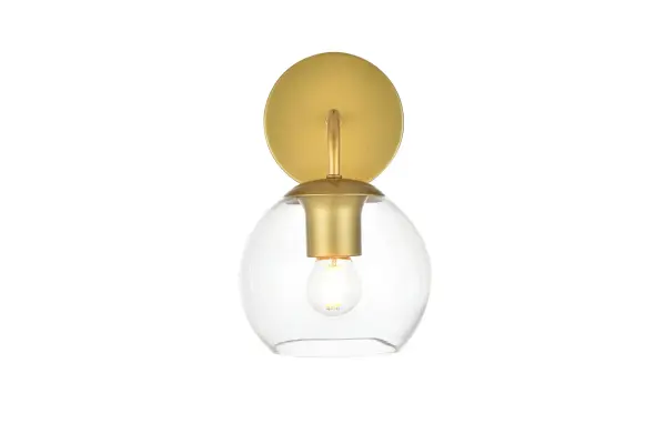 A modern twist on a traditional design, this vanity light is perfect for sprucing up your bathroom. Rated for use in damp locations, this iron fixture features a round backplate, curved arms, and orb accents. Completely versatile, you can place this wall light as an uplight or downlight. Rated for use in damp locations, this will work perfectly over a vanity in your bathroom. Collection: Genesis Rooms: Bathroom Finish: Brass and Clear Glass: Clear Width: 6.00" Height: 10.00" Weight: 1.00 lb Extension from Wall: 8.00" Wire: 8" Black and White Canopy: 4.7"x1"x4.7" Number of Bulbs: 1 Maximum Wattage: 40.00 W Bulb Type: E26 Bulb Base: E26 Dimmable Voltage: 110.00 V Material: Iron and Glass Country of Origin: China Safety Listing: ETL Safety Rating: Damp Title 20 Title 24 Manufacturer Warranty: 1 year limited