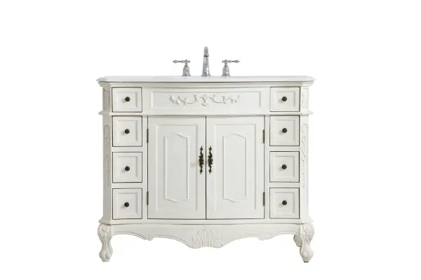 This superb balance of timeless tradition and opulent beauty in a engineered marble-topped vanity will certainly enhance the aesthetics of any home or office bathroom! Featuring an ivory white durable engineered marble countertop complimenting the hand painted cabinet with a delicate carved floral design, stands on stylishly carved solid wood French scroll feet. Don't let the design fool you, the engineered marble countertop and porcelain undermount sink allows for space to get ready, while the antique bronze hardware allows you to discover storage spaces with ease. You and your guests will marvel at this vanity that will both store away your bathroom essentials and enhance the aesthetics of your room. Collection: Danville Rooms: Bathroom Finish: Antique white Width: 21.00" Height: 36.00" Length: 42.00" Weight: 158.00 lb Material: Solid wood and MDF Country of Origin: Vietnam Manufacturer Warranty: 1 year limited