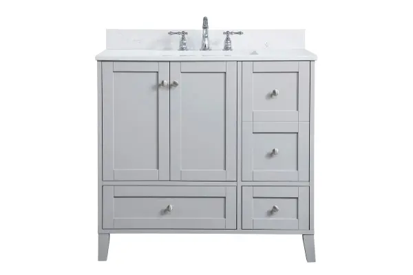 While unassuming, this 36" vanity in a grey finish sure knows how to redefine luxury. The sleek brushed nickel knobs adorn the double cabinet doors and 3 drawers which allow you to store your bathroom toiletries and necessities. Standing strong on oblique legs and dressed with a Calacatta engineered marble countertop, this vanity will surely create beauty and casual elegance in your bathroom or powder room. Comes with a matching backsplash to complete the look and protects your wall. Collection: sommerville Rooms: bathroom Finish: Grey Width: 22.00" Height: 34.00" Length: 36.00" Weight: 166.00 lb Material: MDF Country of Origin: Vietnam Manufacturer Warranty: 1 year limited Spec Sheet