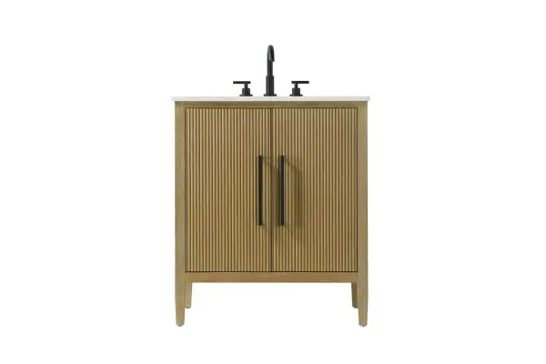 Designed with transitional elegance in mind, this bathroom vanity seamlessly blends traditional elements with modern functionality. Available in five stunning finishes, from the clean sophistication of Crisp White to the natural warmth of Honey Oak, the fluted door and drawer panels add subtle texture and charm. The white engineered marble countertop with natural veining exudes luxury, while the soft-closing doors with sleek black metal pulls offer a quiet, refined experience. Practicality is never compromised, with features like the U-shaped shelf for plumbing, and pre-drilled faucet holes for easy customization. Whether your style leans modern or classic, this vanity is the perfect balance of beauty and function, appealing to customers with a taste for quality and style. Collection: Blakely Rooms: bathroom Finish: Linen Oak Width: 21.50" Height: 35.00" Length: 30.00" Weight: 96.00 lb Material: Solid wood and MDF Country of Origin: Vietnam Manufacturer Warranty: 1 year limited