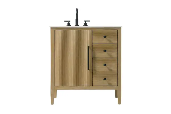 Designed with transitional elegance in mind, this bathroom vanity seamlessly blends traditional elements with modern functionality. Available in five stunning finishes, from the clean sophistication of Crisp White to the natural warmth of Honey Oak, the fluted door and drawer panels add subtle texture and charm. The white engineered marble countertop with natural veining exudes luxury, while the soft-closing doors and drawers with sleek black metal pulls offer a quiet, refined experience. Practicality is never compromised, with features like the U-shaped shelf for plumbing, deeper bottom drawer for ample storage, and pre-drilled faucet holes for easy customization. Whether your style leans modern or classic, this vanity is the perfect balance of beauty and function, appealing to customers with a taste for quality and style. Collection: Blakely Rooms: bathroom Finish: Linen Oak Width: 21.50" Height: 34.00" Length: 32.00" Weight: 128.00 lb Material: Solid wood and MDF Country of Origin: Vietnam Manufacturer Warranty: 1 year limited