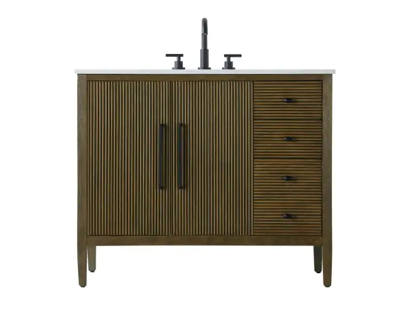 Designed with transitional elegance in mind, this bathroom vanity seamlessly blends traditional elements with modern functionality. Available in five stunning finishes, from the clean sophistication of Crisp White to the natural warmth of Honey Oak, the fluted door and drawer panels add subtle texture and charm. The white engineered marble countertop with natural veining exudes luxury, while the soft-closing doors and drawers with sleek black metal pulls offer a quiet, refined experience. Practicality is never compromised, with features like the U-shaped shelf for plumbing, deeper bottom drawer for ample storage, and pre-drilled faucet holes for easy customization. Whether your style leans modern or classic, this vanity is the perfect balance of beauty and function, appealing to customers with a taste for quality and style. Collection: Blakely Rooms: bathroom Finish: Hazel Oak Width: 21.50" Height: 34.00" Length: 42.00" Weight: 158.00 lb Material: Solid wood and MDF Country of Origin: Vietnam Manufacturer Warranty: 1 year limited