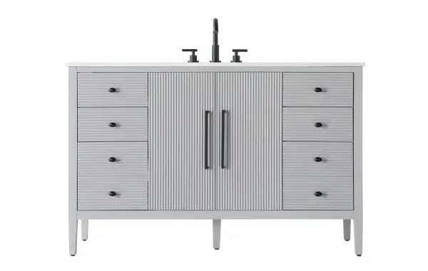 Designed with transitional elegance in mind, this bathroom vanity seamlessly blends traditional elements with modern functionality. Available in five stunning finishes, from the clean sophistication of Crisp White to the natural warmth of Honey Oak, the fluted door and drawer panels add subtle texture and charm. The white engineered marble countertop with natural veining exudes luxury, while the soft-closing doors and drawers with sleek black metal pulls offer a quiet, refined experience. Practicality is never compromised, with features like the U-shaped shelf for plumbing, deeper bottom drawer for ample storage, and pre-drilled faucet holes for easy customization. Whether your style leans modern or classic, this vanity is the perfect balance of beauty and function, appealing to customers with a taste for quality and style. Collection: Blakely Rooms: bathroom Finish: Grey Width: 21.50" Height: 34.00" Length: 54.00" Weight: 221.00 lb Material: Solid wood and MDF Country of Origin: Vietnam Manufacturer Warranty: 1 year limited